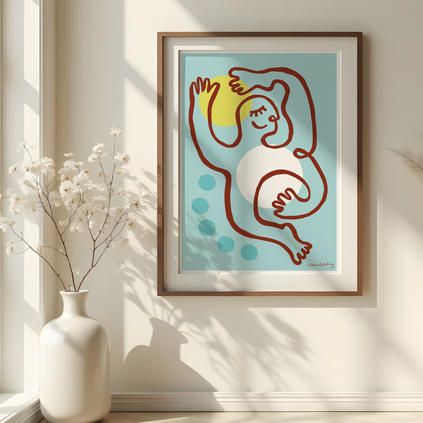 A framed art print featuring a minimalist line drawing of a figure in brown against a light blue background with a yellow sun and teal dots, displayed on a beige wall in a sunlit room with pampas grass in vases.