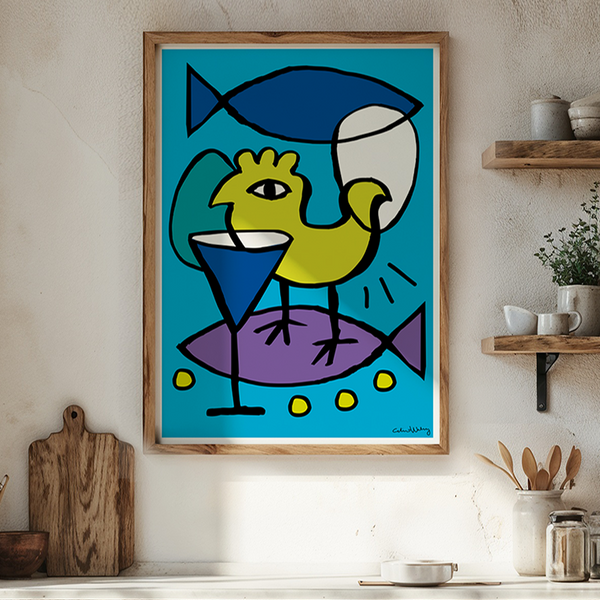 A framed abstract art print featuring a yellow bird and blue fish on a turquoise background, hanging on a beige wall in a bright, modern kitchen with wooden cabinets, a table, and warm natural light.