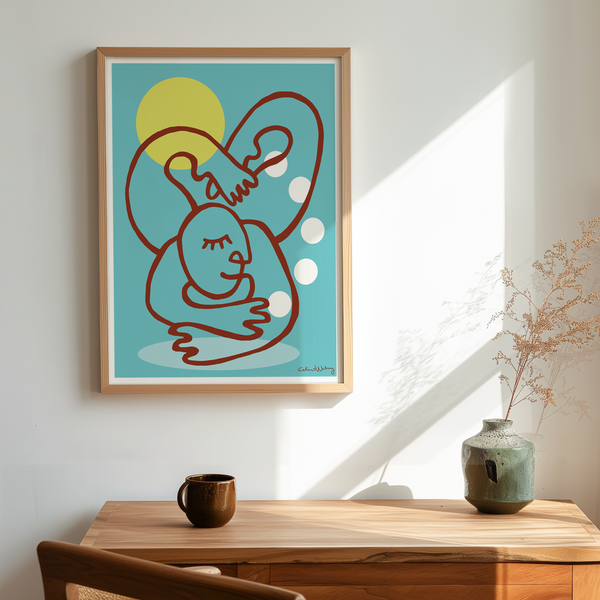 A framed abstract art print featuring a minimalist rabbit illustration hangs on a white wall above a wooden desk with a chair and a vase in a sunlit room.